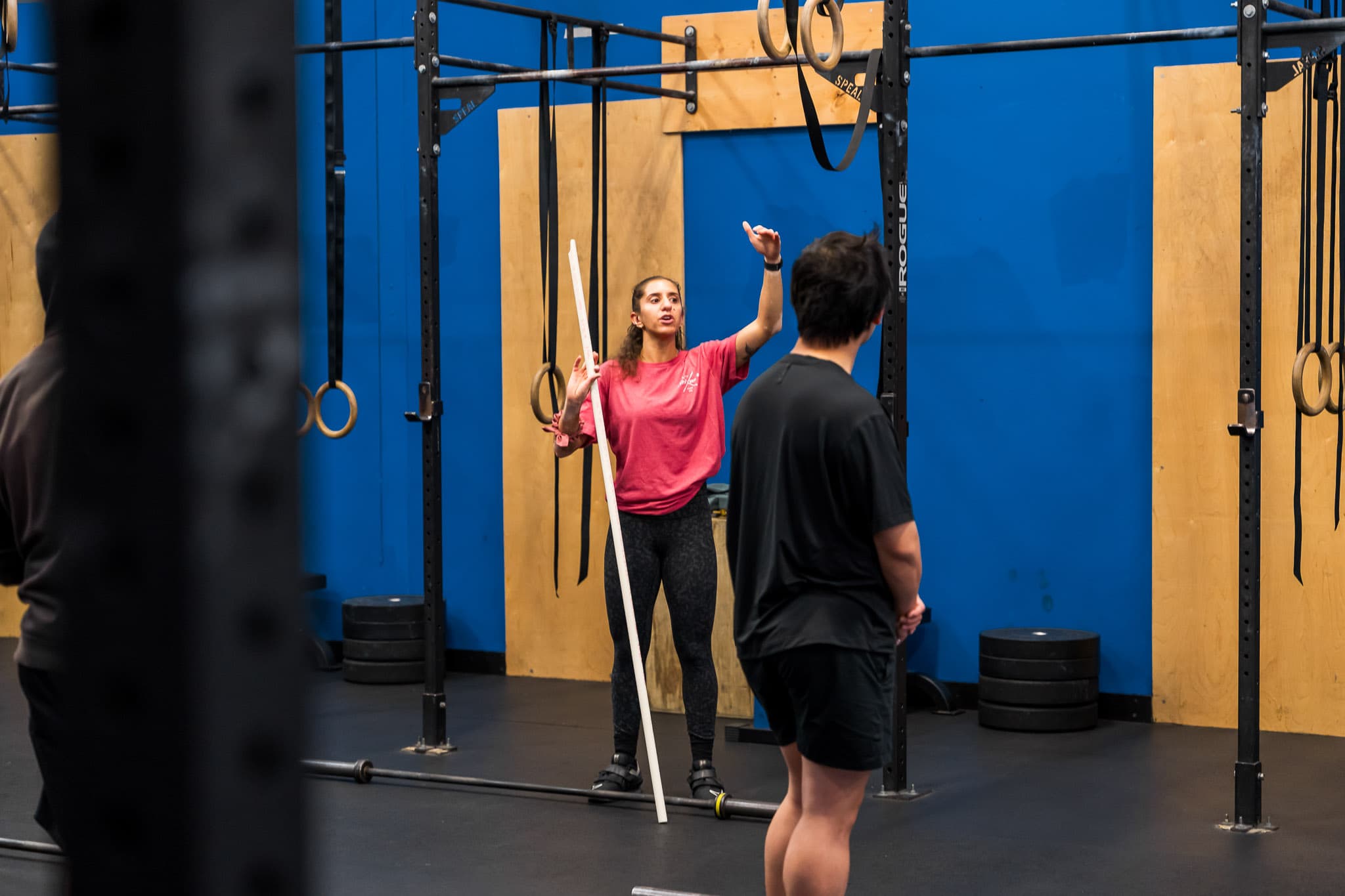 A coach working one-on-one with a member on overhead mobility at Overdrive Athletic Club in Richmond, BC
