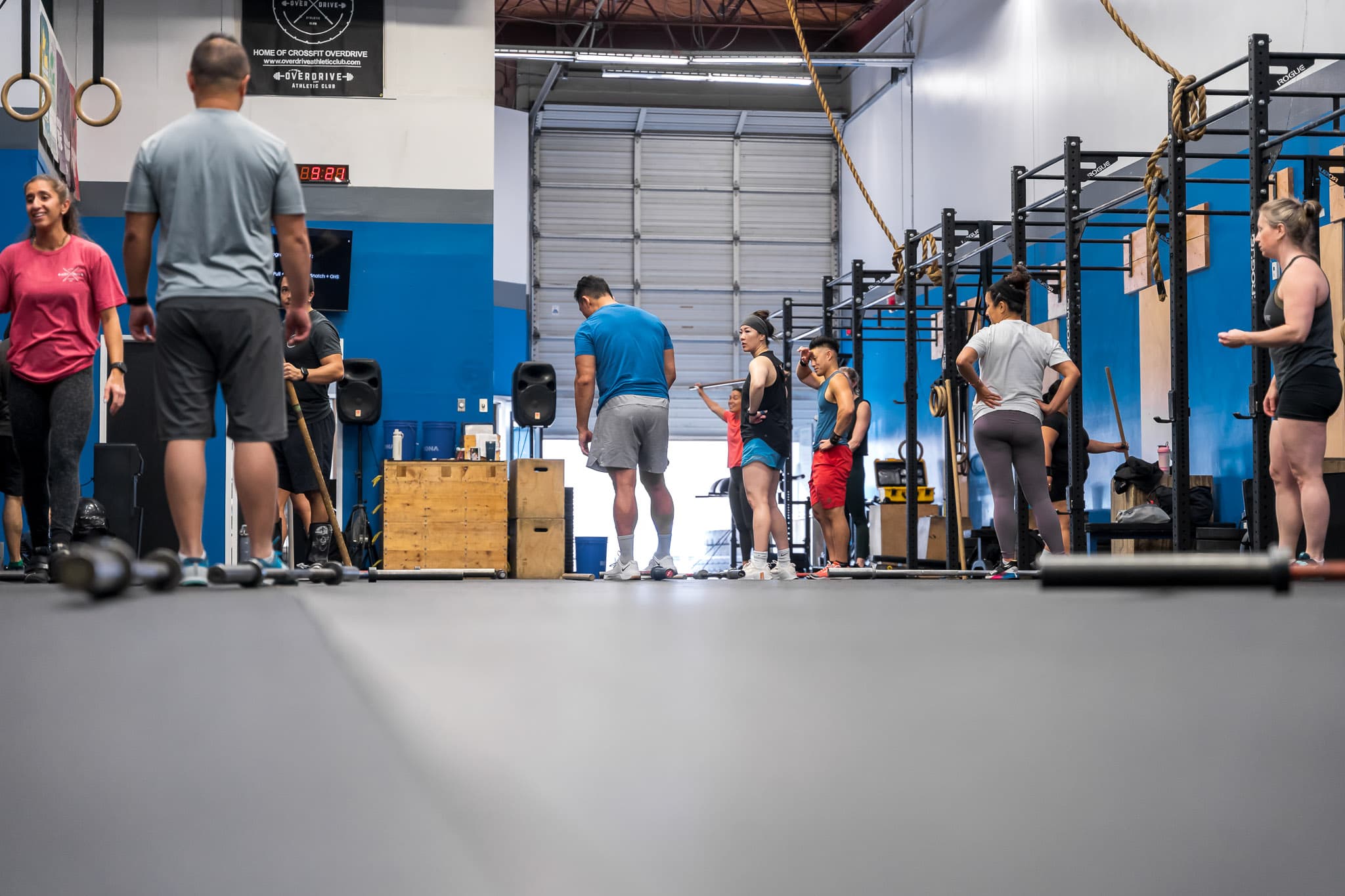 Members on the training floor beside the open garage door at Overdrive Athletic Club in Richmond, BC