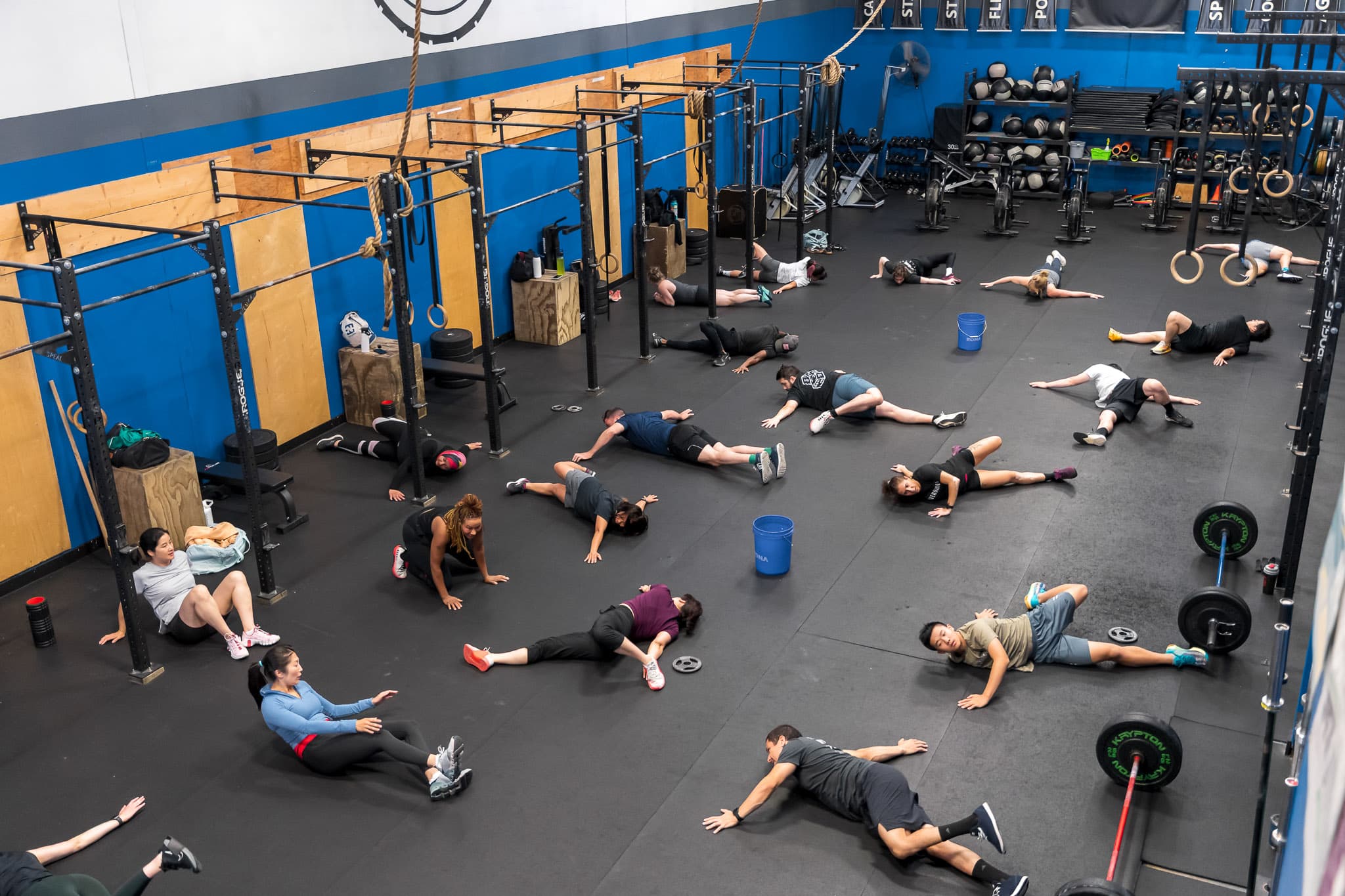 A group fitness class stretching on mats at Overdrive Athletic Club in Richmond, BC