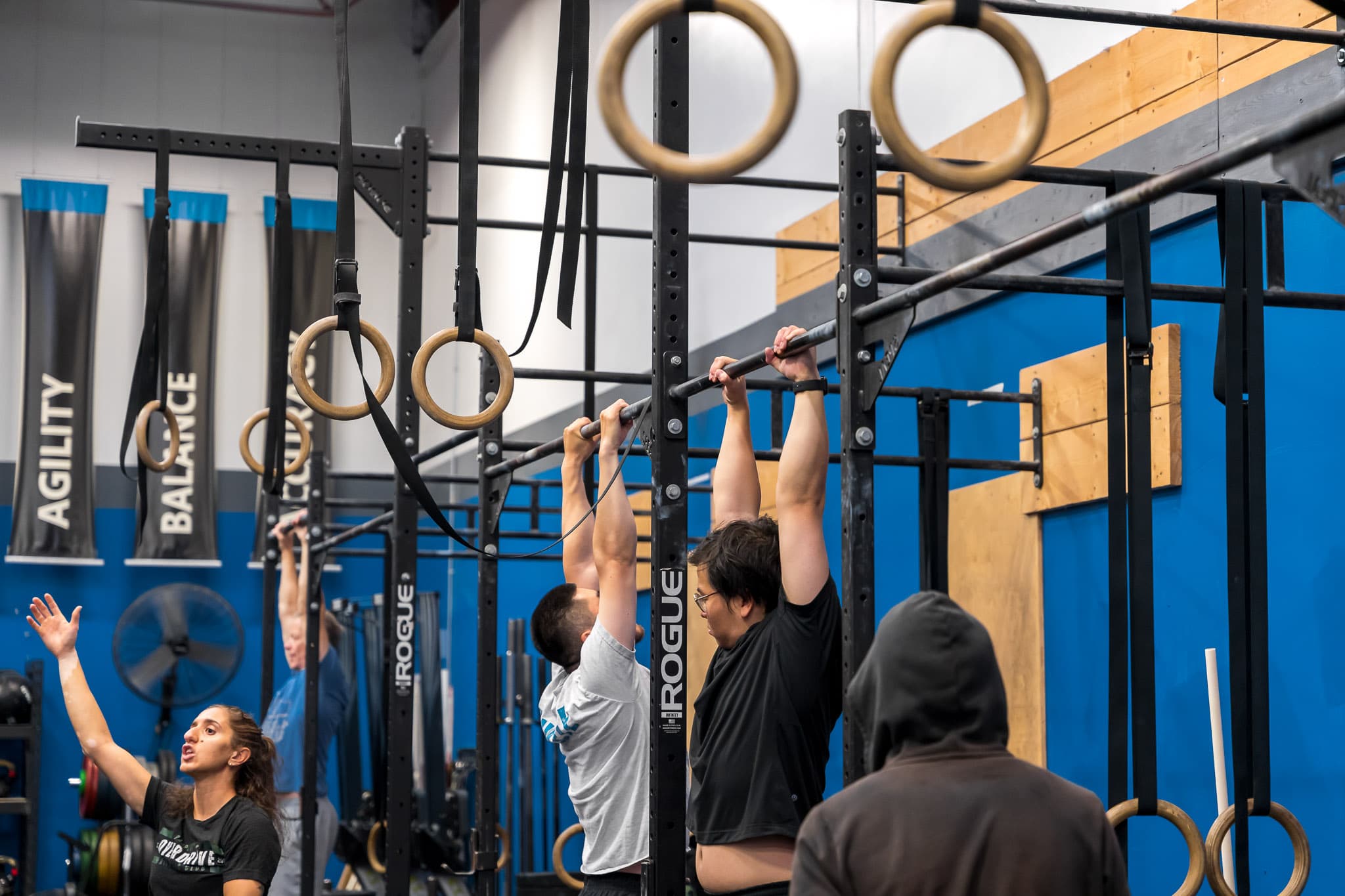 Members performing pull-ups on the rig during a class at Overdrive Athletic Club in Richmond, BC