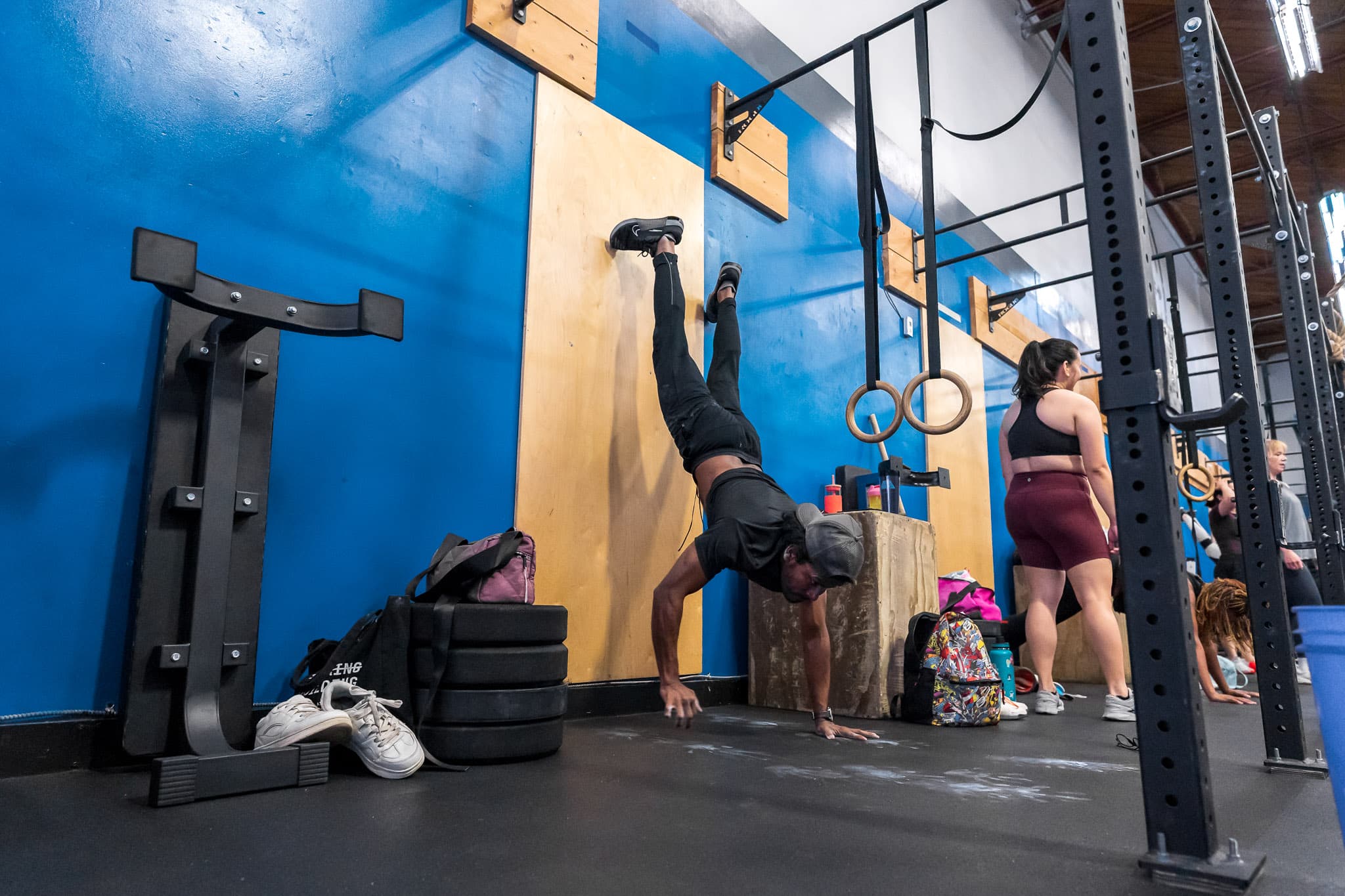 An athlete performing a wall handstand push-up at Overdrive Athletic Club in Richmond, BC