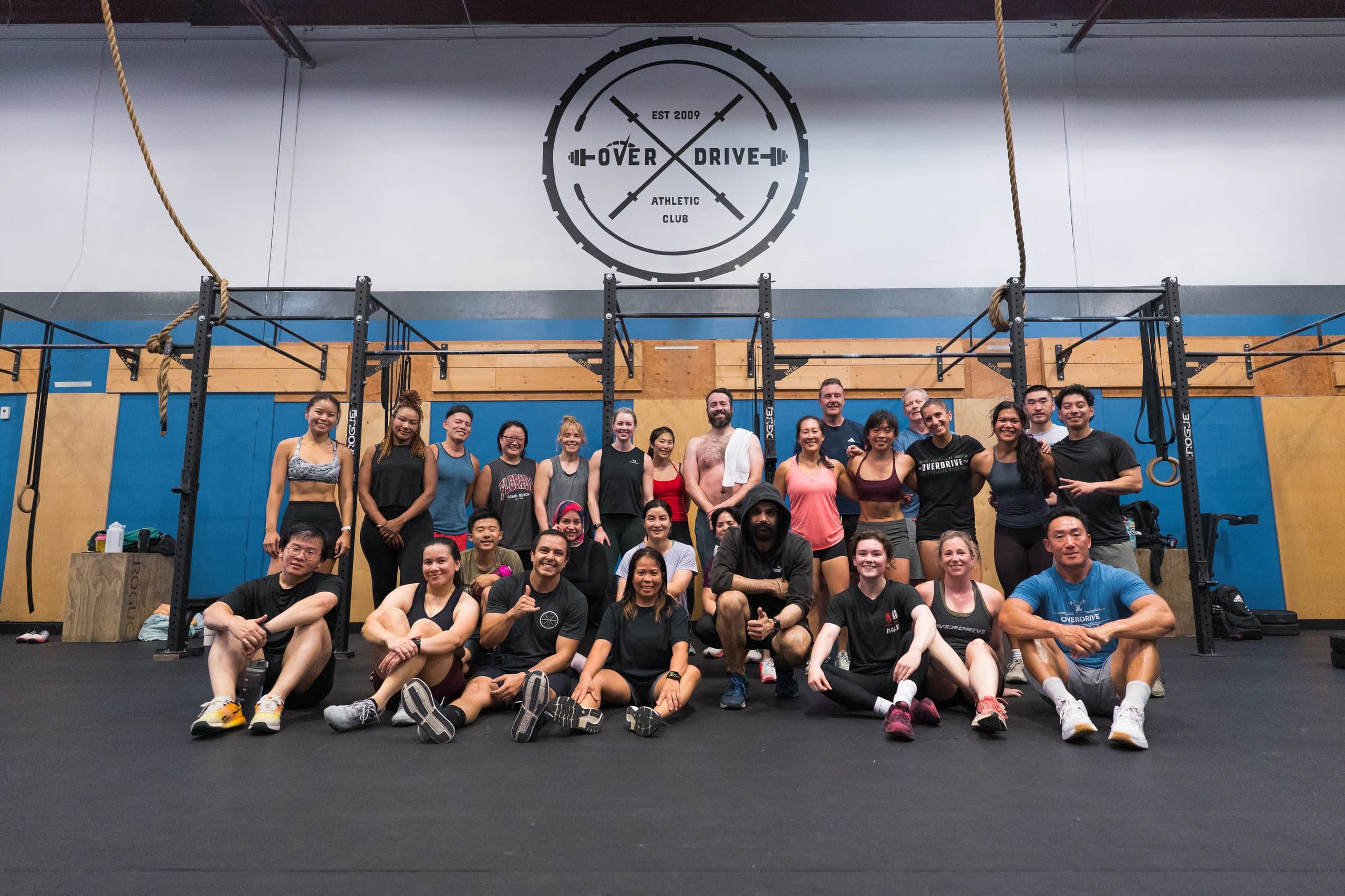 The Overdrive Athletic Club community gathered beneath the club logo inside the gym in Richmond, BC